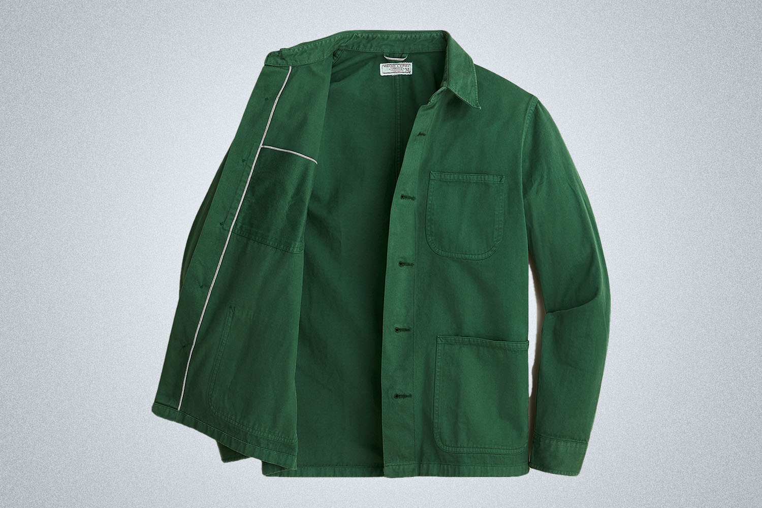 A green chore coat on a grey background